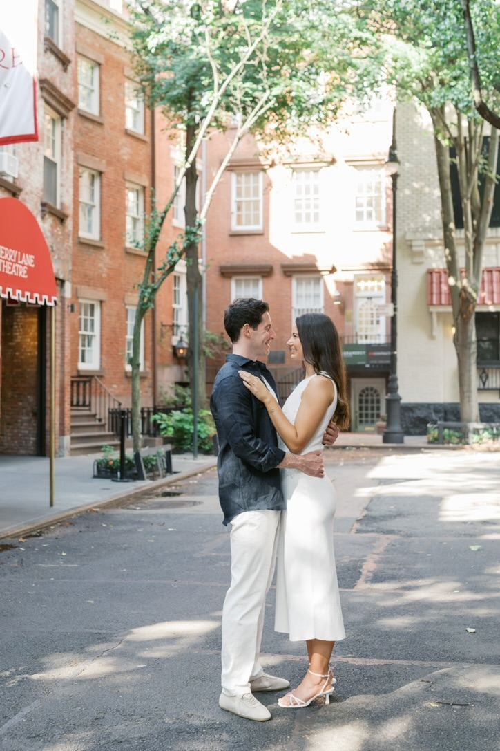 Leah in a white midi dress and Jarryd in a navy linen shirt and white trousers