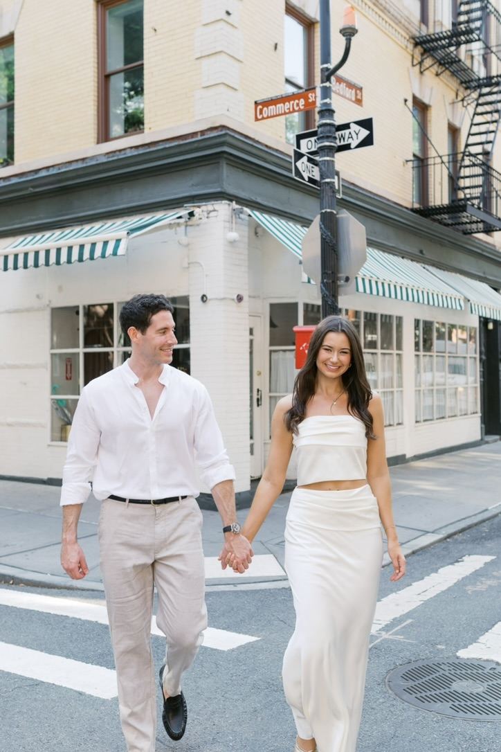 Leah and Jarryd crossing a West Village street hand in hand