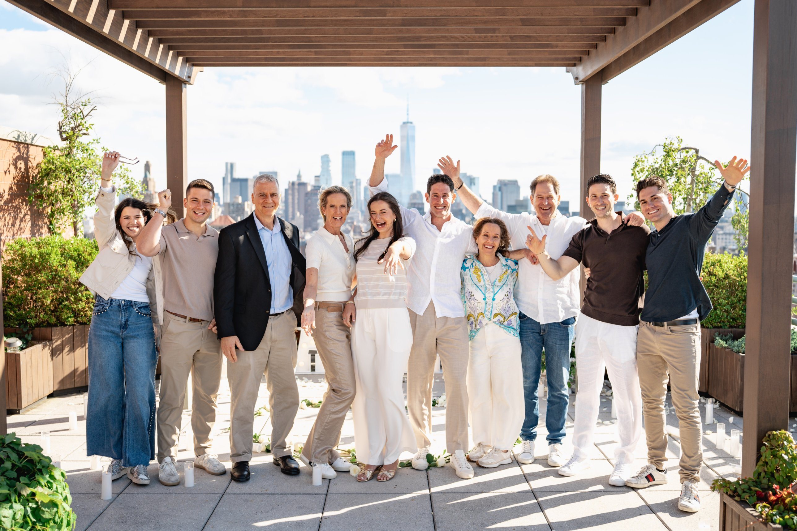 Leah and Jarryd celebrating with both families on the rooftop after the proposal