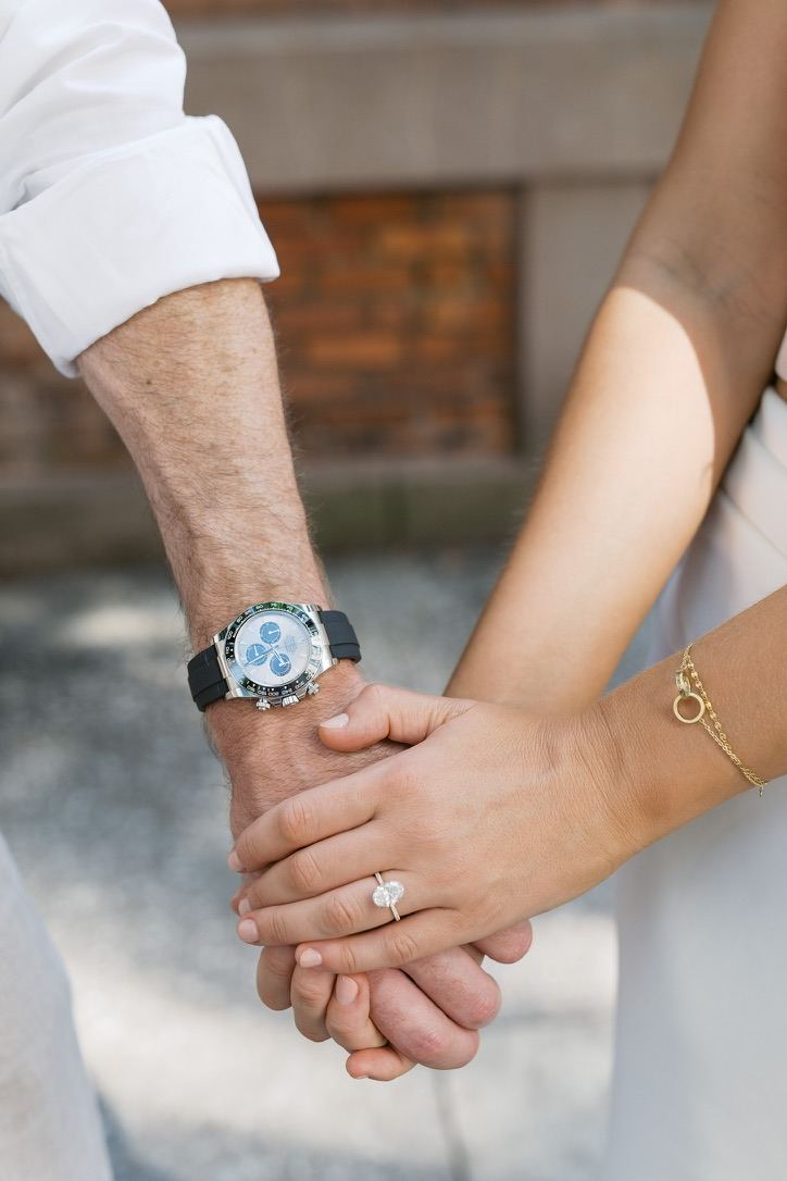 Close-up of Leah and Jarryd's hands with her engagement ring