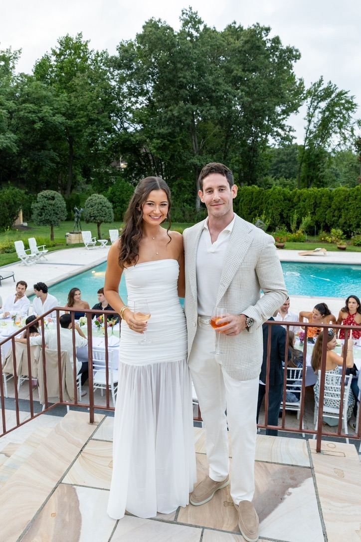 Leah and Jarryd by the pool at their engagement party